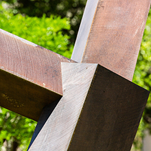 The center of an iron sculpture where large blocks of iron connect, branching out in different directions.