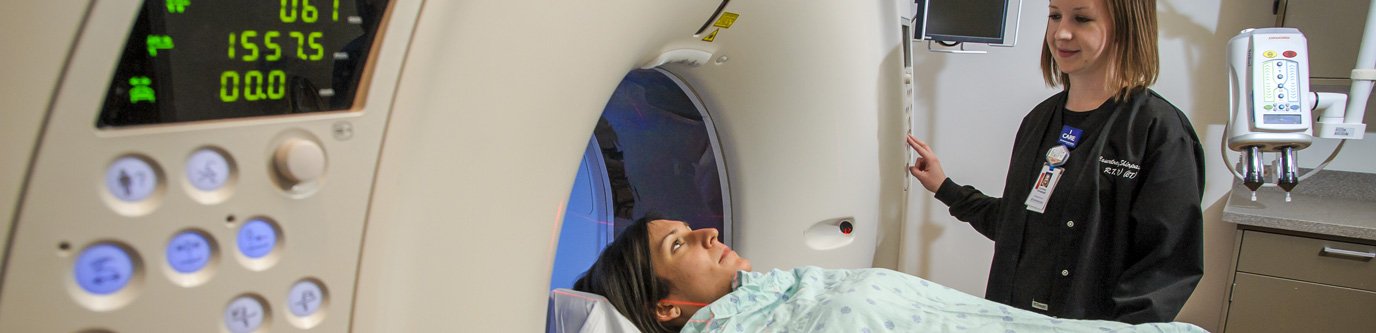 A woman begins an MRI